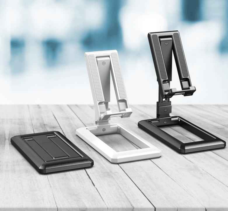 Black and white foldable mobile phone desktop stands on table
